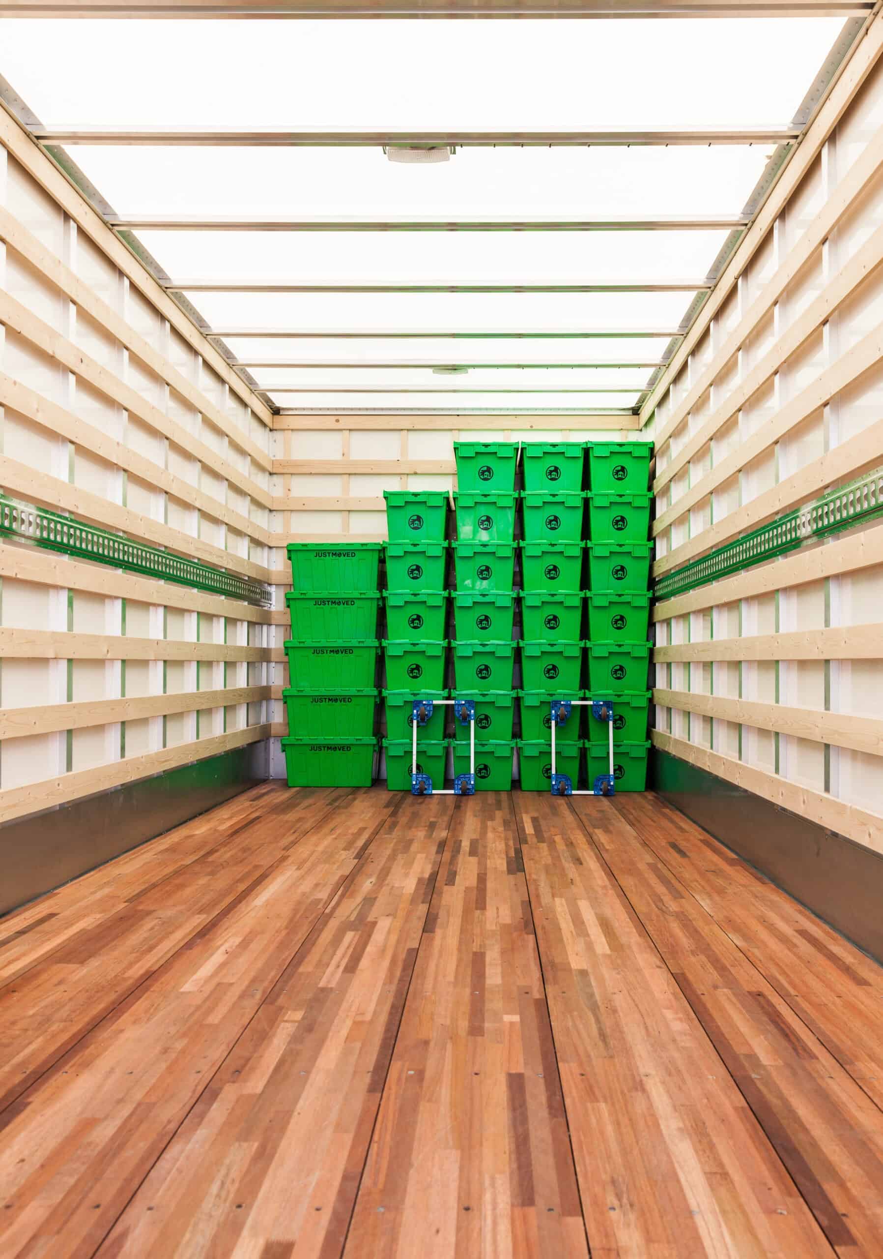 Moving boxes and hand trucks inside a truck for transportation.